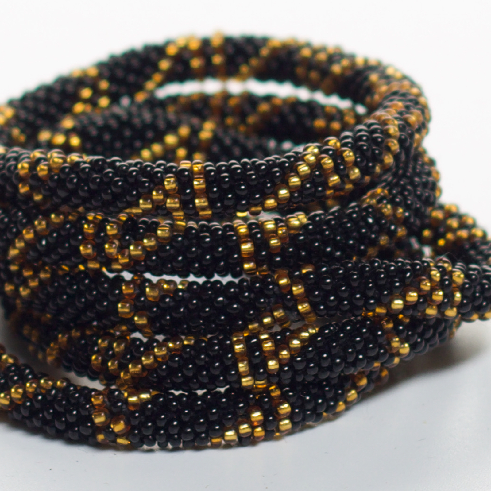 Armbånd med perler i sort og guld