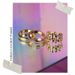 3 guld Arlette anti-stress ringe fra LÉ MOSCH – med sten, tekstur og drejefunktion, vist på spejl.